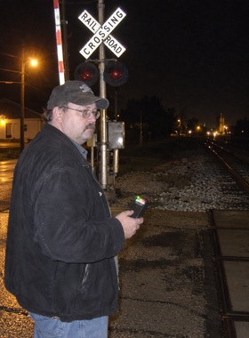 Dale Hutchins at Washington Street platform at night, holding EMF meter, platform lighting, October 2008